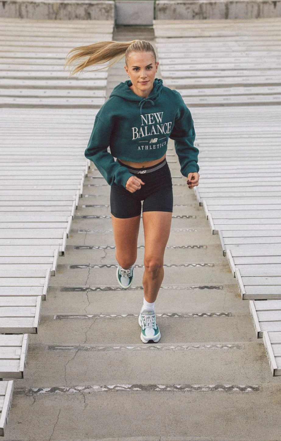 Parker Valby running up bleacher stairs 